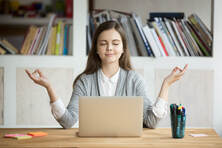 student or professional meditating online in the office or school 